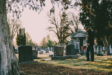 man visiting someone in the cemetery